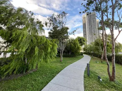 a walking path in a park with a tall building at Trion KL By Paradgm Nest Stay Free Parking in Kuala Lumpur
