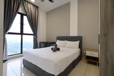 a bedroom with a bed with a teddy bear on it at Trion KL By Paradgm Stay With Balcony in Kuala Lumpur