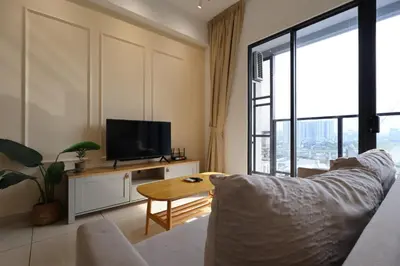 a living room with a couch and a tv at Trion KL By Paradgm Stay With Balcony in Kuala Lumpur