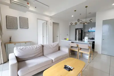 a living room with a white couch and a table at Trion KL By Paradgm Stay With Balcony in Kuala Lumpur