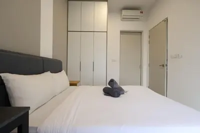 a stuffed animal sitting on top of a bed at Trion KL By Paradgm Stay With Balcony in Kuala Lumpur