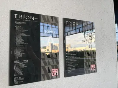 two posters on a wall with a view of a city at Trion KL By Paradgm Stay With Balcony in Kuala Lumpur