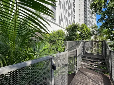 a walkway leading up to a building with plants at Trion KL By Paradgm Stay With Balcony in Kuala Lumpur