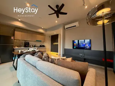 a living room with a couch and a tv at Isola KLCC by HeyStay Management in Kuala Lumpur