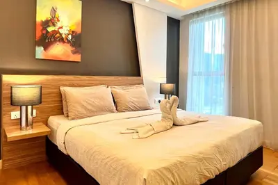 a bedroom with a large bed in a room at High-Floor Suasana KL Stay Cozy & Central in Kuala Lumpur