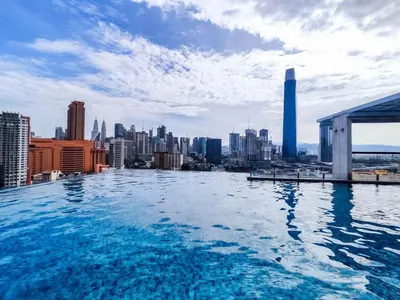 a infinity pool with a view of a city at KL City Designer Studio in D Majestic near LRT and Lalaport CityNest in Kuala Lumpur