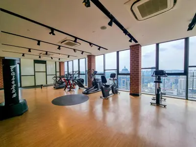 a gym with treadmills and exercise bikes in a room with windows at KL City Designer Studio in Ceylonz with KL118 Tower View CityNest in Kuala Lumpur