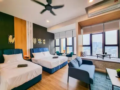 a hotel room with two beds and a couch at KL City Designer Studio in Ceylonz with KL118 Tower View CityNest in Kuala Lumpur