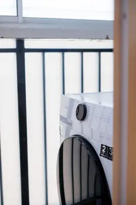 a washing machine sitting in front of a window at Bright 3BR Kids Café Home Slide LEGO Playroom in Kuala Lumpur