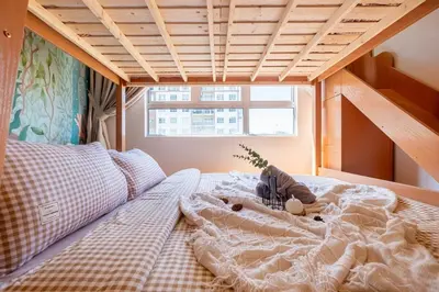 a teddy bear laying on a bed in a bedroom at Bright 3BR Kids Café Home Slide LEGO Playroom in Kuala Lumpur