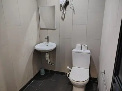 a small bathroom with a toilet and a sink at Fahrenheit 88 Suites, Bukit Bintang 4R in Kuala Lumpur