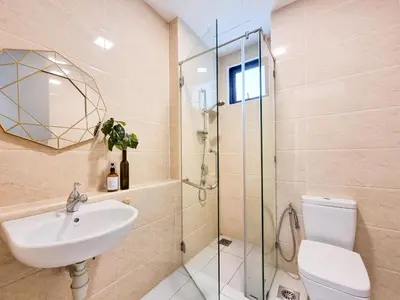 a bathroom with a toilet and a sink and a shower at One Residences Family Suites KL by CityNest in Kuala Lumpur