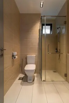 a bathroom with a toilet and a shower at One Residences Family Suites KL by CityNest in Kuala Lumpur