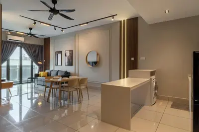 a kitchen and living room with a table and chairs at One Residences Family Suites KL by CityNest in Kuala Lumpur