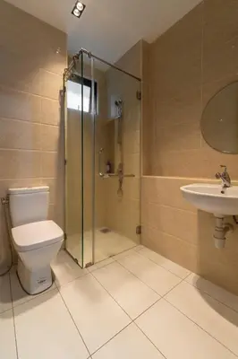 a bathroom with a shower and a toilet and a sink at One Residences Family Suites KL by CityNest in Kuala Lumpur