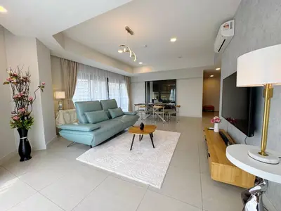 a living room with a blue couch and a table at The Atrium Jalan Ampang Elegant Fully Air-Con 3 BR Homestay in Kuala Lumpur