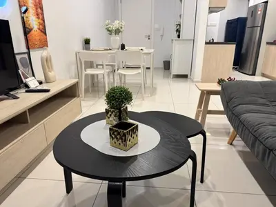 a living room with a table and a couch at Robertson S23A KLCC Bukit Bintang Jalan Alor Petaling Street 2R 7Pax in Kuala Lumpur