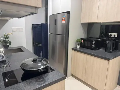 a kitchen with a stainless steel refrigerator and a counter at Robertson S23A KLCC Bukit Bintang Jalan Alor Petaling Street 2R 7Pax in Kuala Lumpur