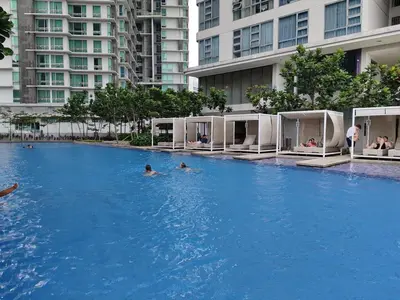 people swimming in a large pool in a building at Robertson S23A KLCC Bukit Bintang Jalan Alor Petaling Street 2R 7Pax in Kuala Lumpur