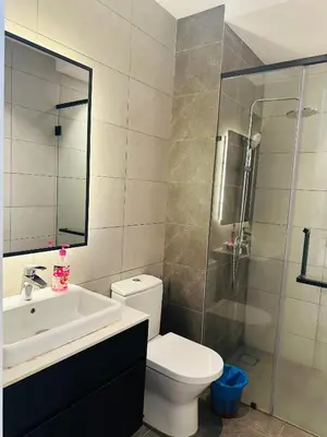 a bathroom with a toilet and a sink and a shower at Bukit Bintang Axon Residence By TRX in Kuala Lumpur