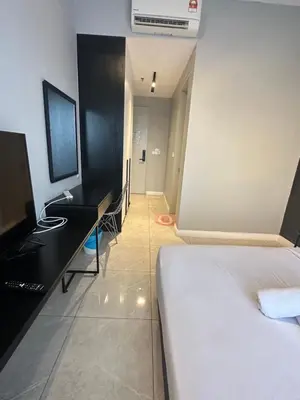 a bedroom with a bed and a desk with a computer at Bukit Bintang Axon Residence By TRX in Kuala Lumpur