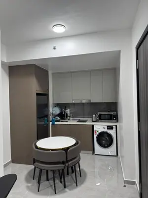 a kitchen with a table and two chairs and a stove at Agile Bukit Bintang By ERYSHAH in Kuala Lumpur