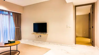 a hotel room with a flat screen tv on the wall at Eaton Residence KLCC - Royal Home in Kuala Lumpur