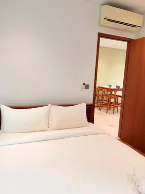 a bedroom with a white bed and a table at Sky Suites KLCC by Apartment TD Luxury in Kuala Lumpur