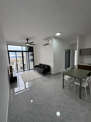 a living room with a table and a couch at star resdence in Kuala Lumpur