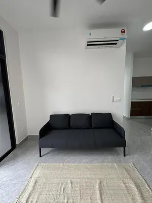 a black couch sitting in a living room at star resdence in Kuala Lumpur