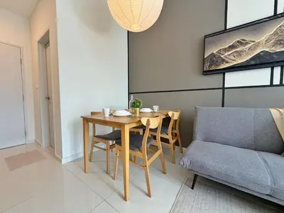 a dining room with a table and a couch at KLCC View Majestic Lovely Studio with Rooftop Pool in Kuala Lumpur