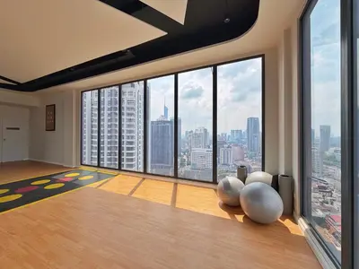 a room with a large window with a view of a city at KLCC View Majestic Lovely Studio with Rooftop Pool in Kuala Lumpur