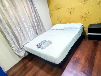 a bed with two mitts on it in a room at Cahaya Hanson BilikXpert in Kuala Lumpur
