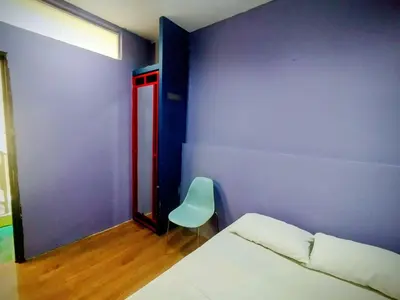 a room with a bed and a chair in it at Cahaya Hanson BilikXpert in Kuala Lumpur