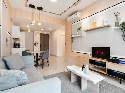 a living room with a couch and a flat screen tv at Continew Facing TRX View 10MIN TO KLCC With PS4 in Kuala Lumpur