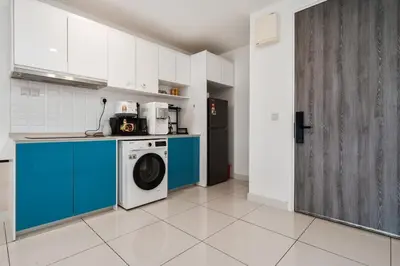 a kitchen with a washer and a washing machine at Continew Facing TRX View 10MIN TO KLCC With PS4 in Kuala Lumpur