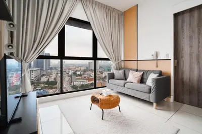 a living room with a couch and large windows at Continew Residence 10MIN To KLCC With Board Games Fit Up To 6PAX in Kuala Lumpur