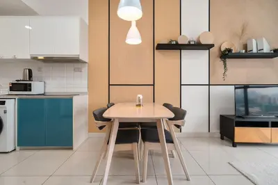 a kitchen with a wooden table and chairs in a room at Continew Residence 10MIN To KLCC With Board Games Fit Up To 6PAX in Kuala Lumpur