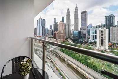 a balcony with a view of the city at Legasi Residence Direct KLCC VIEW Only10minWalkToKLCC With PS4 AndBoardGames in Kuala Lumpur