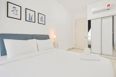 a white bedroom with a large bed and a window at Legasi Residence Direct KLCC VIEW Only10minWalkToKLCC With PS4 AndBoardGames in Kuala Lumpur
