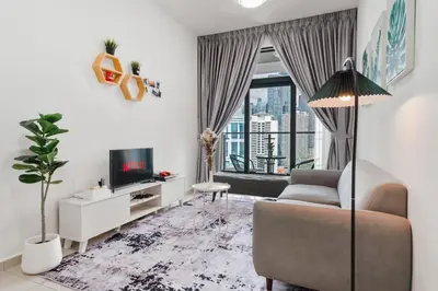 a living room with a couch and a tv at Legasi Residence Direct KLCC VIEW Only10minWalkToKLCC With PS4 AndBoardGames in Kuala Lumpur
