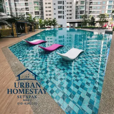 three chairs in a swimming pool in a building at Urban Homestay Setapak MHP2 Kids Friendly in Kuala Lumpur