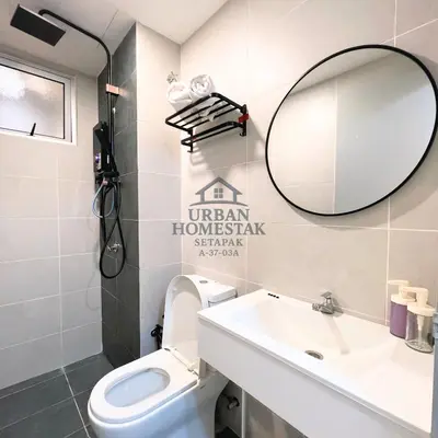 a bathroom with a white toilet and a mirror at Urban Homestay Setapak MHP2 Kids Friendly in Kuala Lumpur