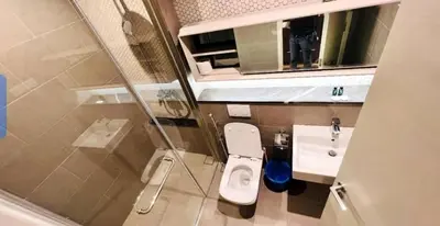 a small bathroom with a toilet and a sink at Lucentia Residence in Kuala Lumpur