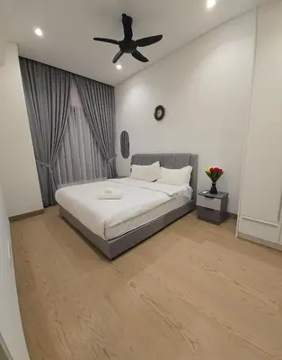 a bedroom with a bed with a ceiling fan at Lucentia Residence in Kuala Lumpur