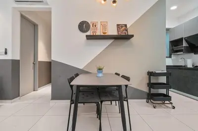 a table and chairs in a room with a kitchen at Kenwingston Platz 15 MINS TO KLCC Fit 5 Pax With Board games in Kuala Lumpur
