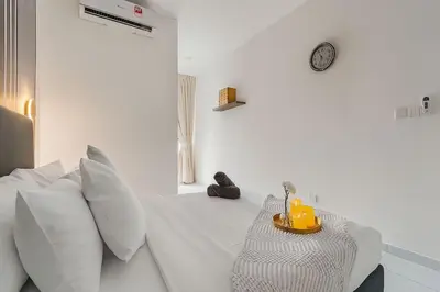 a white bedroom with a bed with white pillows at Kenwingston Platz 15Mins To KLCC Fit 9Pax Modern Interior B25 in Kuala Lumpur