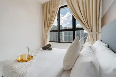 a bedroom with a white bed with a large window at Kenwingston Platz 15Mins To KLCC Fit 9Pax Modern Interior B25 in Kuala Lumpur
