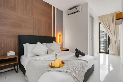 a bedroom with a bed with two candles on it at Kenwingston Platz 15MINS TO KLCC Modern Interior Boardgames A26 in Kuala Lumpur