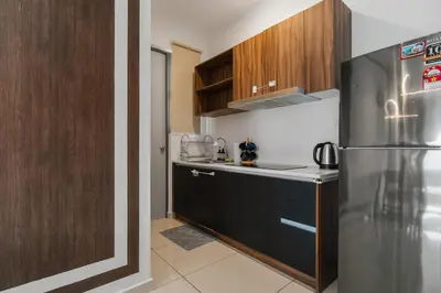 a kitchen with a stainless steel refrigerator and wooden cabinets at Kenwingston Platz 15MINS TO KLCC Modern Interior Boardgames A26 in Kuala Lumpur